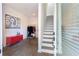 The entryway features stairs, a red cabinet, a coat rack and white walls at 1606 Rock Dam Dr # 11, Atlanta, GA 30317