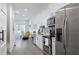 Bright kitchen featuring white cabinets, stainless steel appliances, and an adjacent dining area at 1606 Rock Dam Dr # 11, Atlanta, GA 30317