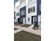 The townhouse has a modern design, with a blue and white facade and well-maintained landscaping at 1606 Rock Dam Dr # 11, Atlanta, GA 30317