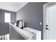 Walk-in closet featuring grey wall, white cabinetry, and plenty of storage at 1606 Rock Dam Dr # 11, Atlanta, GA 30317