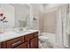 Bathroom with white countertops, wood cabinets, a shower and a bathtub at 3210 Steinbeck St, Cumming, GA 30041