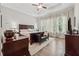 Bedroom with hardwood floors, ceiling fan, and bench at 3210 Steinbeck St, Cumming, GA 30041