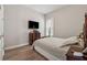 Bedroom with wood floors, a wood bed frame, and a flat screen TV at 3210 Steinbeck St, Cumming, GA 30041