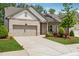 Single-story home featuring a brick facade, well-manicured lawn, and an attached two-car garage at 3210 Steinbeck St, Cumming, GA 30041
