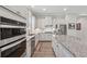 Bright kitchen featuring stainless appliances, granite countertops, and a breakfast bar at 3210 Steinbeck St, Cumming, GA 30041
