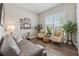 Comfortable living room featuring a gray couch, hardwood floors and natural lighting at 3210 Steinbeck St, Cumming, GA 30041