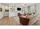 Comfortable living room with hardwood floors, built-in shelving, a fireplace, and lots of natural light at 3210 Steinbeck St, Cumming, GA 30041