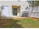 Fenced backyard features a small patio area with sliding glass doors leading into the home at 3216 Panthers Trce, Decatur, GA 30034