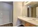 Bathroom featuring a vanity with white countertop, a mirror, and a shower with a glass door at 3216 Panthers Trce, Decatur, GA 30034
