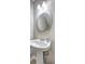 Bathroom pedestal sink with oval mirror and light fixture at 3216 Panthers Trce, Decatur, GA 30034