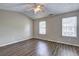 Bright bedroom featuring laminate floors, vaulted ceiling, and two large windows at 3216 Panthers Trce, Decatur, GA 30034