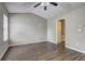 Bedroom features wood-look flooring, a ceiling fan, and a vaulted ceiling at 3216 Panthers Trce, Decatur, GA 30034