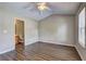 Bedroom featuring laminate floors, neutral walls, ceiling fan, and ensuite bathroom at 3216 Panthers Trce, Decatur, GA 30034