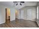 Bedroom featuring wood-look floors, ensuite bath, and multiple closets and doors at 3216 Panthers Trce, Decatur, GA 30034