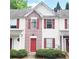 Charming townhouse with red door, shutters, brick facade and manicured landscaping at 3216 Panthers Trce, Decatur, GA 30034