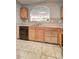 Kitchen area showcasing wooden cabinets, black dishwasher, sink and tile floor at 3216 Panthers Trce, Decatur, GA 30034