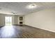 Open living room featuring wood flooring, a cozy fireplace, and sliding door to the backyard at 3216 Panthers Trce, Decatur, GA 30034