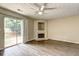Bright living room with modern ceiling fan, fireplace, and sliding glass door to the exterior at 3216 Panthers Trce, Decatur, GA 30034