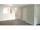 Open-concept living room with hardwood floors, white walls, and an arched doorway at 3216 Panthers Trce, Decatur, GA 30034