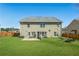 Rear exterior of the home with sliding glass doors, a patio, and a spacious, fenced backyard at 5015 Scuppernong Ct, Austell, GA 30106