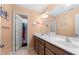 Bright bathroom with double sinks, framed mirror, and a shower with a colorful curtain at 5015 Scuppernong Ct, Austell, GA 30106