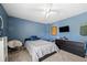 Blue bedroom with a queen bed, ceiling fan, and large dresser for ample storage space at 5015 Scuppernong Ct, Austell, GA 30106