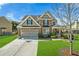 Charming two-story home with a brick facade, well-manicured lawn, and an attached two-car garage at 5015 Scuppernong Ct, Austell, GA 30106