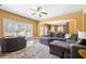 Bright living room featuring a large sectional sofa, area rug, and ample natural light at 5015 Scuppernong Ct, Austell, GA 30106
