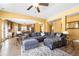Inviting living room featuring hardwood floors, large sectional sofa and seamlessly flowing to the kitchen area at 5015 Scuppernong Ct, Austell, GA 30106