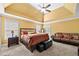 Spacious main bedroom with a tray ceiling, plush carpet, and comfortable seating area at 5015 Scuppernong Ct, Austell, GA 30106