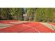 Outdoor community basketball court with red painted key and black chainlink fence at 7491 Hilltop Way, Atlanta, GA 30349
