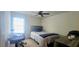 Cozy bedroom with a ceiling fan and a large window for natural light at 7491 Hilltop Way, Atlanta, GA 30349
