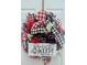Festive 'Home Sweet Home' wreath with red, black, and white checkered ribbons and floral accents on the front door at 7491 Hilltop Way, Atlanta, GA 30349