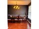 Dining room with hardwood floors, updated chandelier, and natural light at 7491 Hilltop Way, Atlanta, GA 30349