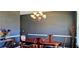Dining room with dark walls, white trim, a traditional chandelier, and a wooden dining table at 7491 Hilltop Way, Atlanta, GA 30349