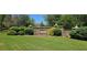 Well-maintained community entrance sign surrounded by lush landscaping and manicured lawns at 7491 Hilltop Way, Atlanta, GA 30349