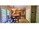 Well-lit kitchen with stainless steel appliances, wooden cabinets, tiled backsplash, and a breakfast bar at 7491 Hilltop Way, Atlanta, GA 30349