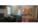 Open-concept living room and kitchen area with hardwood floors, fireplace, and comfortable seating at 7491 Hilltop Way, Atlanta, GA 30349