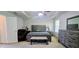 Spacious bedroom with tray ceiling features a full furniture set, carpet, and natural light at 7491 Hilltop Way, Atlanta, GA 30349