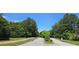 Quiet neighborhood street lined with mature trees and manicured lawns in a residential area at 7491 Hilltop Way, Atlanta, GA 30349