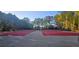 Community tennis courts surrounded by lush greenery, perfect for recreational activities at 7491 Hilltop Way, Atlanta, GA 30349