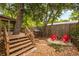 Outdoor seating area with wood-burning fire pit surrounded by mature trees and foliage at 165 Hale Ne St, Atlanta, GA 30307