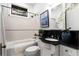 Updated bathroom featuring modern fixtures, tile surround, and granite vanity at 165 Hale Ne St, Atlanta, GA 30307