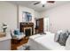 Sun-filled bedroom with ceiling fan, hardwood floors, a fireplace, and open doorway at 165 Hale Ne St, Atlanta, GA 30307