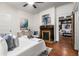 Cozy bedroom featuring a brick fireplace, hardwood floors, and an abundance of natural light at 165 Hale Ne St, Atlanta, GA 30307