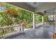 Relaxing covered porch with a swing, ceiling fan, and views of the landscaped front yard at 165 Hale Ne St, Atlanta, GA 30307