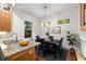 Dining room with large window, elegant lighting, and view to the kitchen at 165 Hale Ne St, Atlanta, GA 30307