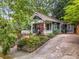 Two-story blue home featuring a covered porch, a driveway, and mature trees at 165 Hale Ne St, Atlanta, GA 30307
