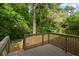 Wood deck that overlooks the backyard filled with lush green foliage and trees at 2223 Columbia Dr, Decatur, GA 30032