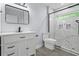 Updated bathroom featuring a vanity, toilet, glass enclosed shower with marble tile and modern fixtures at 2223 Columbia Dr, Decatur, GA 30032